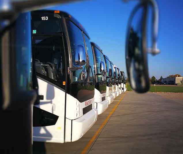 Lineup of front of Windstar Buses in a Parking Lot