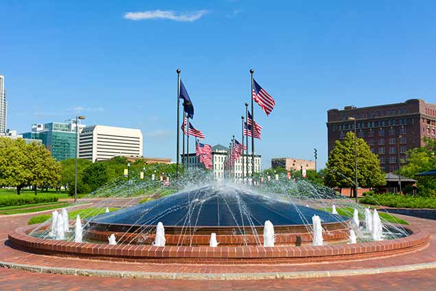 Fountain in Omaha, NE with flags surrounding it