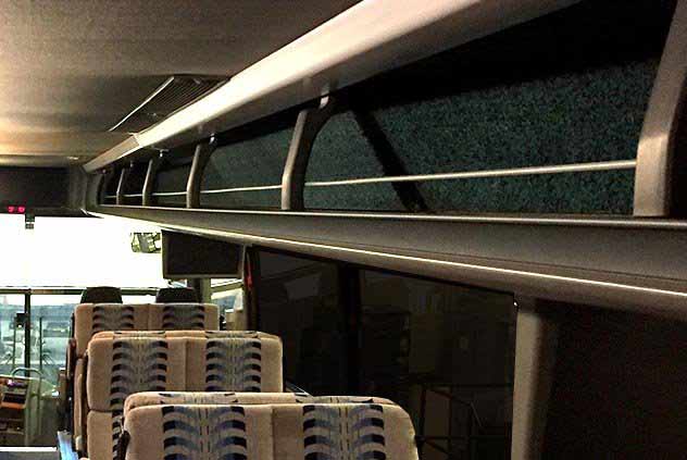 Interior Luggage rack and cloth covered seats of Windstar bus