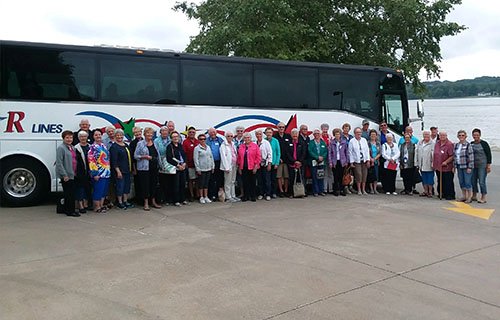 tour operators standing in front of Windstar Lines motorcoach
